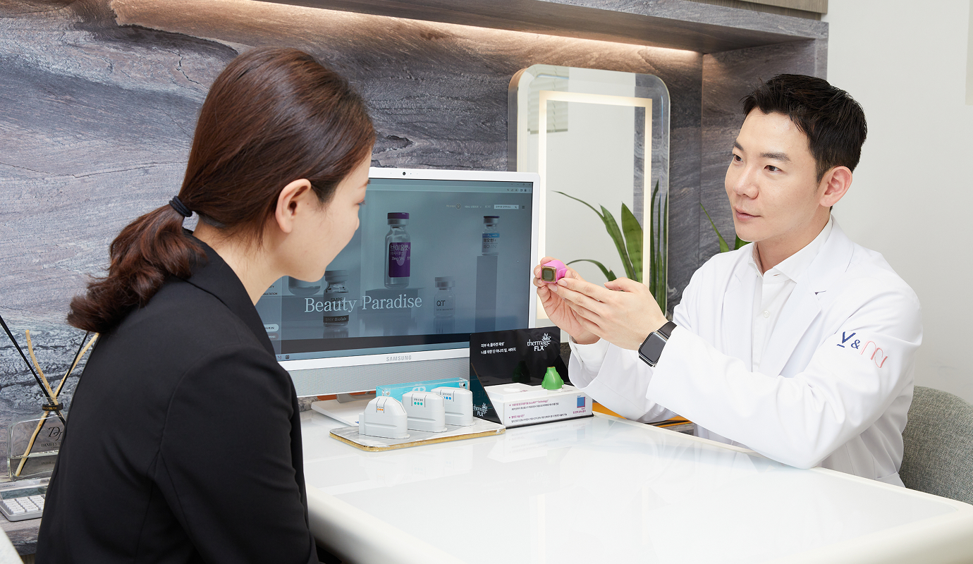 江南駅 目元リフティング専門皮膚科V&MJ皮膚科医院でアイサーマクール推奨施術のイ・ビョンドゥ院長が目元のたるみについて相談する様子